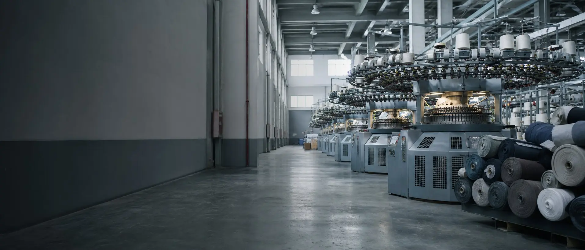 Circular knitting machines and fabric rolls at a custom fabric manufacturer in Karachi